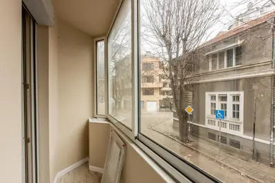 an empty room with a window looking out at a street at Blue Тerrace Apartment Top Center in Varna City