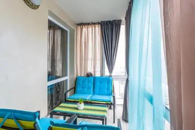 a room with blue chairs and a window at Blue Тerrace Apartment Top Center in Varna City