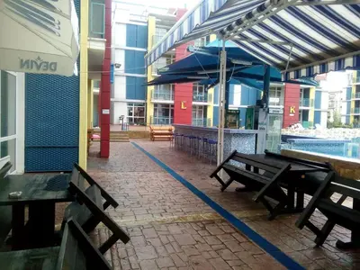 a patio with benches and a pool in a building at Studios in Complex Elit 4 in Sunny Beach