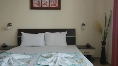 a bedroom with a bed with two towels on it at Sani Holiday Village in Sozopol