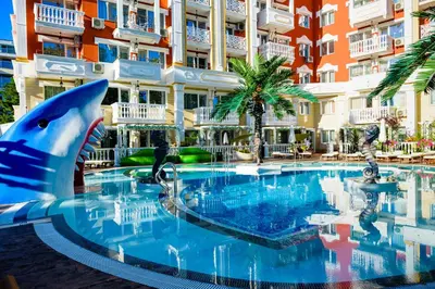 a pool with a shark in front of a building at Sweet Homes 6 Apartments in Sunny Beach