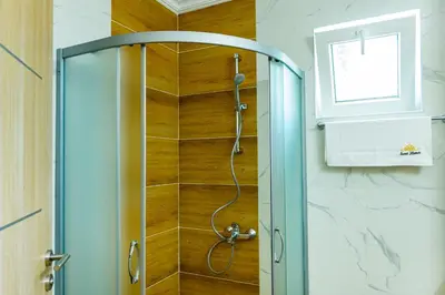 a shower with a glass door in a bathroom at Sweet Homes 6 Apartments in Sunny Beach