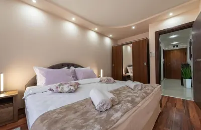a bedroom with a large bed with towels on it at Apartment Aventurine in Varna City