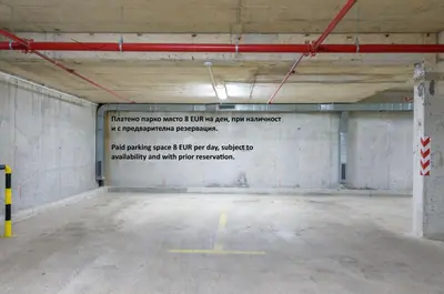 an empty parking garage with a sign on the wall at Apartment Aventurine in Varna City