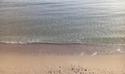 a view of the beach with footprints in the sand at Studio Stoianovi in Nesebar