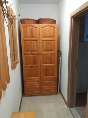a wooden cabinet with two baskets on top of it at Апартамент Термите in Varna City