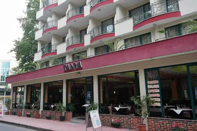 a hotel with a red and white building at Tanya Hotel in Sunny Beach