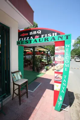 a sign for a fish restaurant in front of a building at Tanya Hotel in Sunny Beach