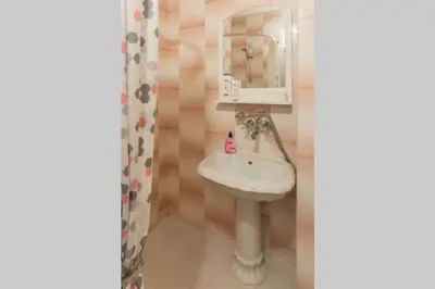 a bathroom with a sink and a mirror at Kapriz - 2 beds aptmnt near the beach in Varna City