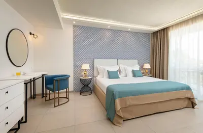 a bedroom with a bed and a desk and a mirror at Siena Premium Retreat in Lozenets