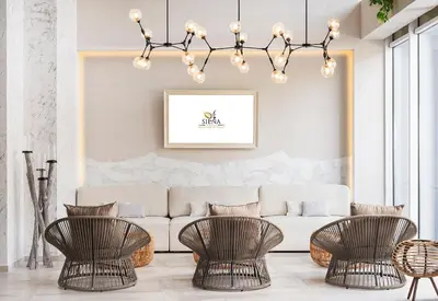 a living room with a couch and two chairs at Siena Premium Retreat in Lozenets