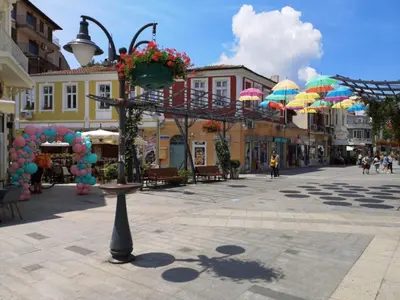 a city street with umbrellas in the middle of a town at Hotel Sunny Bay Pomorie in Pomorie