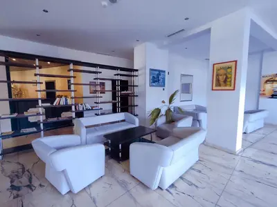 a living room with white chairs and a table at Moonlight Hotel - All Inclusive in Sveti Vlas