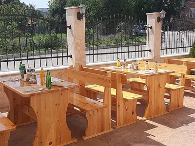a wooden table and benches on a patio at Hotel Santa Maria in Obzor