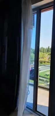 a window with a view of a tennis court at Apartament CACAO RESIDENCE in Sunny Beach