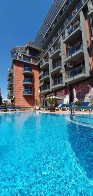a large swimming pool in front of a building at Apartament CACAO RESIDENCE in Sunny Beach