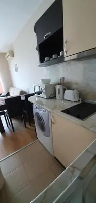 a kitchen with a washing machine and a stove at Apartament CACAO RESIDENCE in Sunny Beach