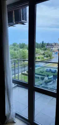 a window with a view of a street outside at Apartament CACAO RESIDENCE in Sunny Beach