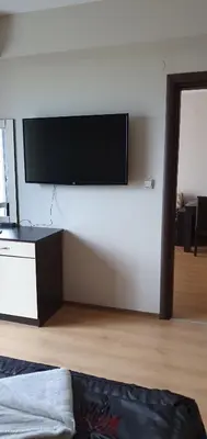 a living room with a flat screen tv on a wall at Apartament CACAO RESIDENCE in Sunny Beach