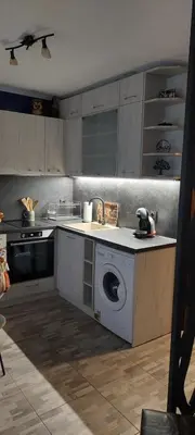a kitchen with a washing machine in the middle at Апартамент Морска Звезда in Nesebar