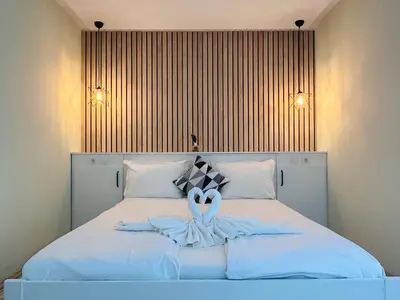 a bedroom with a bed with two swans on it at PARADISO 'В' 311 Private Studio Nesebar in Nesebar