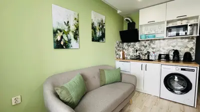 a living room with a couch and a washing machine at PARADISO 'В' 311 Private Studio Nesebar in Nesebar
