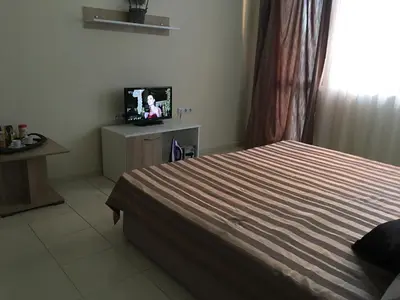 a bedroom with a bed and a tv in it at Apart Hotel salt Lake in Pomorie