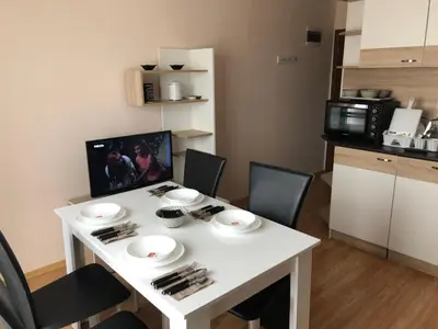 a small kitchen with a white table and chairs at Palace De Luxe - Apartments in Pomorie