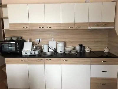 a kitchen with white cabinets and a microwave at Palace De Luxe - Apartments in Pomorie