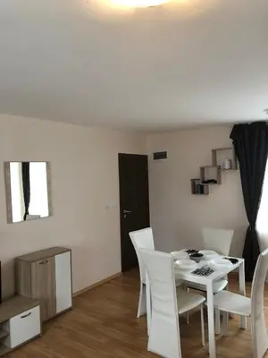 a white dining room with a white table and chairs at Palace De Luxe - Apartments in Pomorie