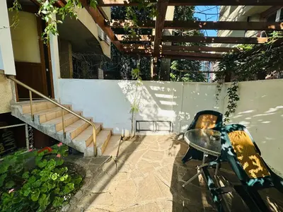 a bike parked next to a building with a table and stairs at STUDIO KATRIN in Nesebar