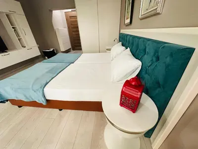 a bedroom with a bed with a red box on a table at STUDIO KATRIN in Nesebar
