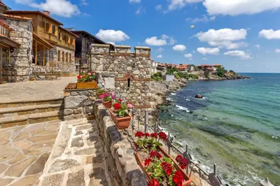 a stone wall with flowers on the beach at Marina Sands Bijou Boutique is an excellent choice for travelers visiting Obzor in Obzor