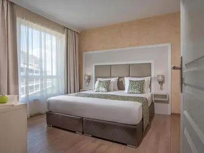 a bedroom with a large bed and a large window at Marina Sands Bijou Boutique is an excellent choice for travelers visiting Obzor in Obzor