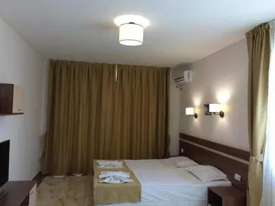 a bedroom with a bed and a window with curtains at Flower Street provides accommodations with free Wifi, air conditioning in Sunny Beach