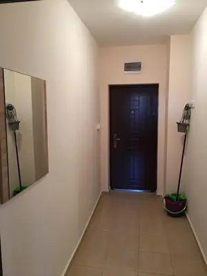 a hallway with a black door and a tile floor at Elite Apartments is located in the old town of Pomorie in Pomorie