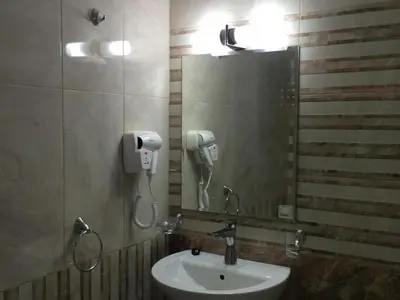 a bathroom with a sink and a mirror and a phone at Hotel Tm Deluxe located in Sunny Beach in Sunny Beach
