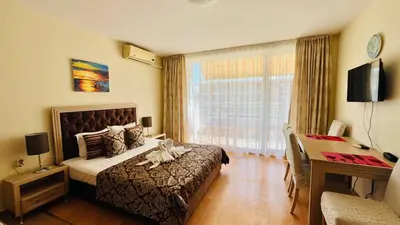 a bedroom with a bed and a desk and a window at FORT NOKS NESSEBAR B2-216 Studio SUNNY BEACH in Sunny Beach