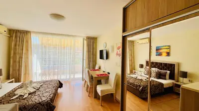 a hotel room with two beds and a desk at FORT NOKS NESSEBAR B2-216 Studio SUNNY BEACH in Sunny Beach