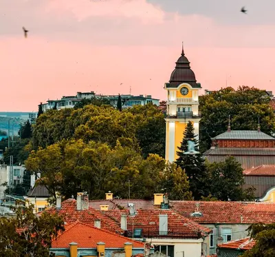 a clock tower in a city with roofs at Salt Lake ApartHotel in Pomorie