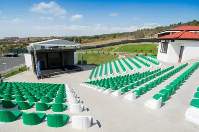 a group of green and white chairs in front of a stage at Nevis Resort & Aqua Park - All Inclusive in Sunny Beach