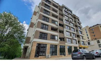a large building with cars parked in front of it at K&K Stylish Elegance in Burgas City