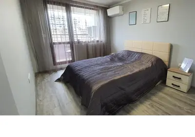 a bedroom with a large bed and a window at K&K Stylish Elegance in Burgas City