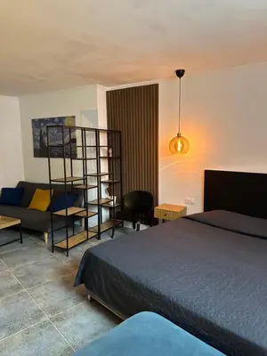 a bedroom with a bed and a living room at Hotel Art in Varna City