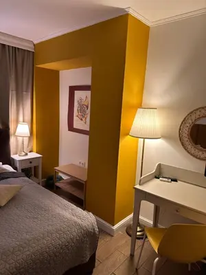 a hotel room with a bed and a desk at Hotel Art in Varna City