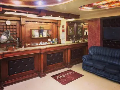 a bar in a pub with a leather couch at Hotel Art in Varna City