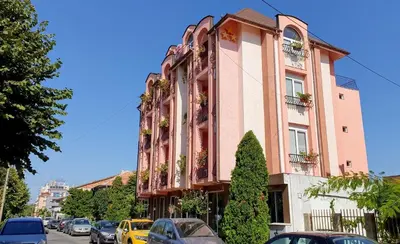 a building with cars parked in front of it at Art Villa Rozalia in Ravda