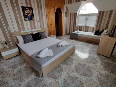 a large bedroom with a large bed and a television at Art Villa Rozalia in Ravda