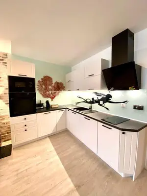a large kitchen with white cabinets and a sink at Sea View NewApartment-Bulgaria-Chernomorets in Chernomorets