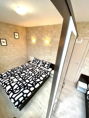 a bedroom with a black and white bed in a room at Sea View NewApartment-Bulgaria-Chernomorets in Chernomorets
